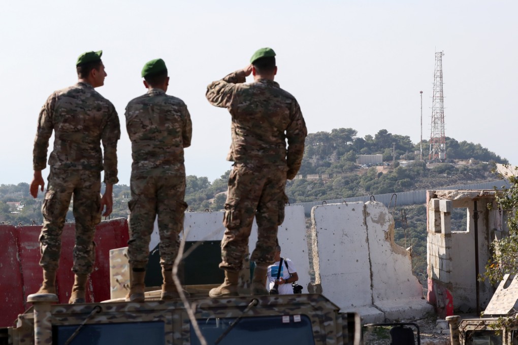 Lebanese army soldiers stand atop a military vehicle overlooking Hanita, an Israeli military base, near the border with Israel in southern Lebanon, last month. Photo: EPA