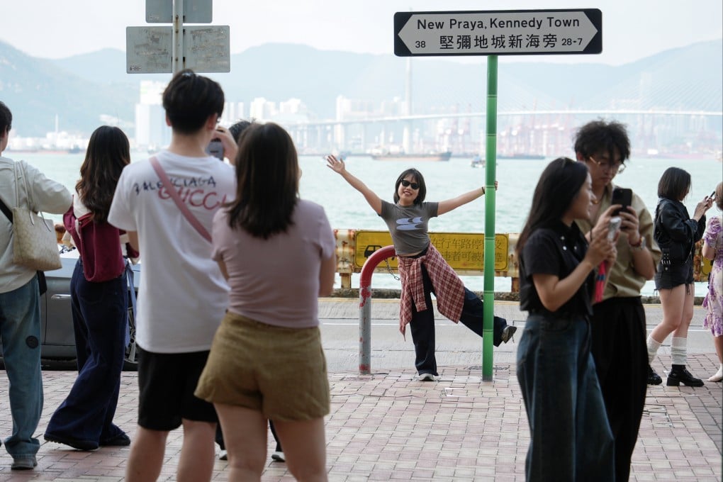 Tourists from the mainland take pictures in Kennedy Town on the last day of the “golden week” holiday on October 8. Photo: Eugene Lee