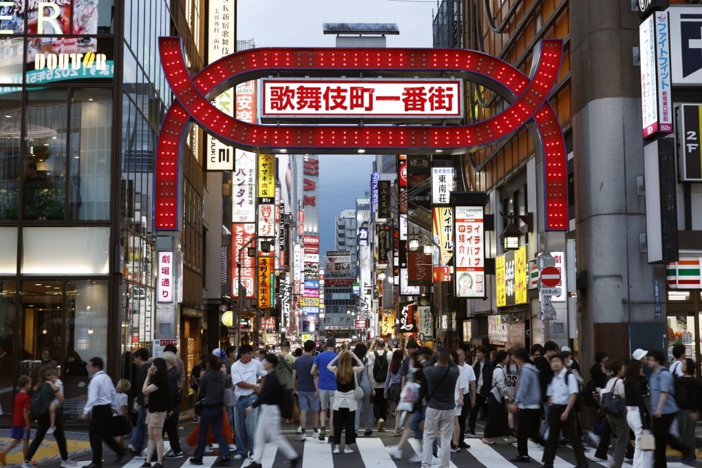 People walk past an entrance gate of Kabukicho, Tokyo’s red-light district, in Shinjuku, Japan. Photo: EPA-EFE