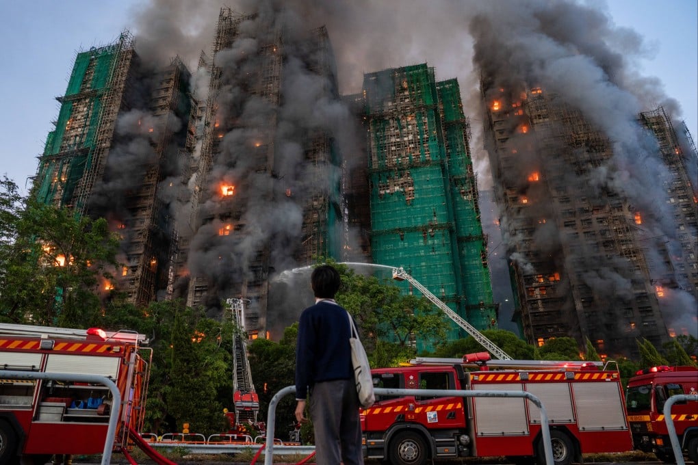 A person watches as a major fire engulfs residential buildings at Wang Fuk Court in Hong Kong on November 26. Photo: dpa