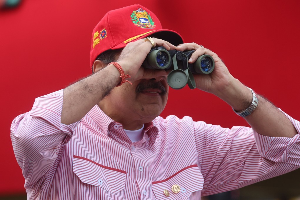 Venezuelan President Nicolas Maduro looks through binoculars during a rally in Caracas on Monday. Photo EPA