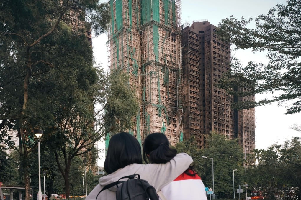 Friends Irena Leung (left) and Valerie Kwok, both 15, hug in front of the Wang Fuk Court housing estate, in Tai Po, on November 28. Photo: Alexander Mak