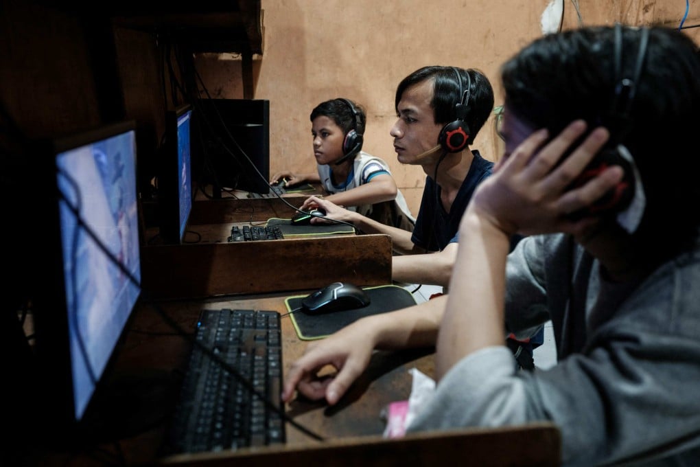 Young men play online games and surf the internet at a cyber cafe in Jakarta last month. Photo: AFP