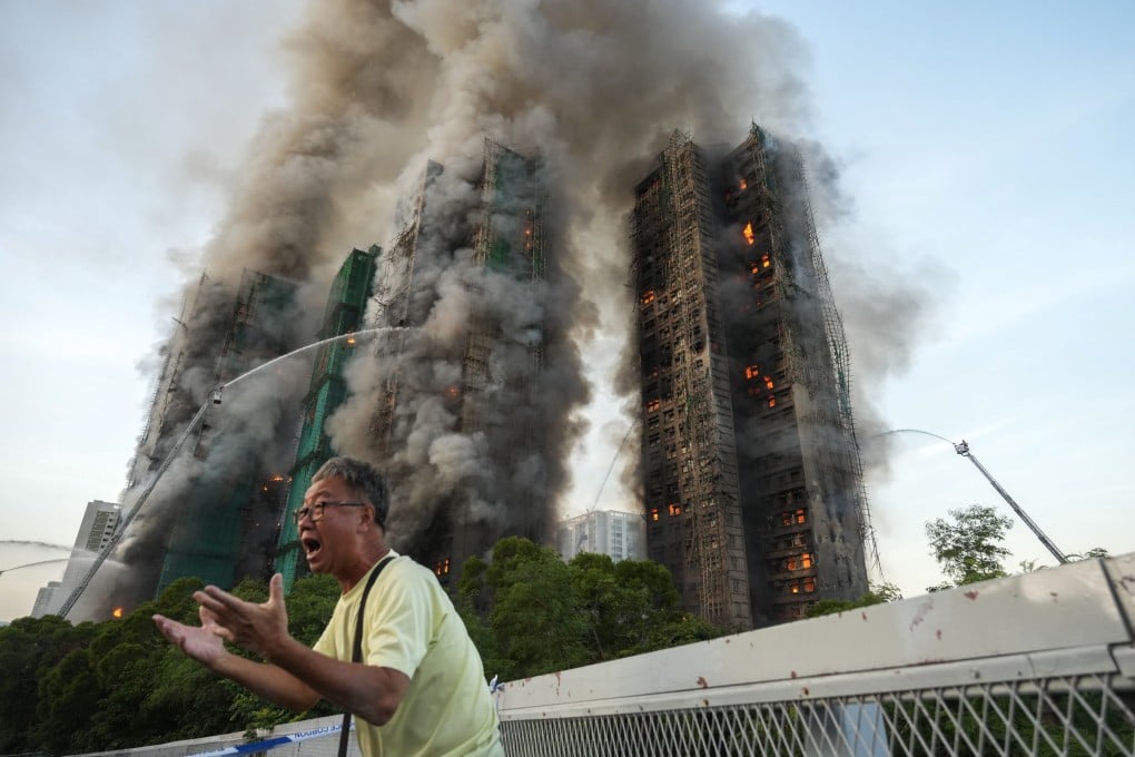 A 71-year-old man, surnamed Wong, breaks down in tears, saying his wife is trapped inside Wang Fuk Court as fire engulfs the housing blocks in Tai Po on November 26. Photo: Sam Tsang