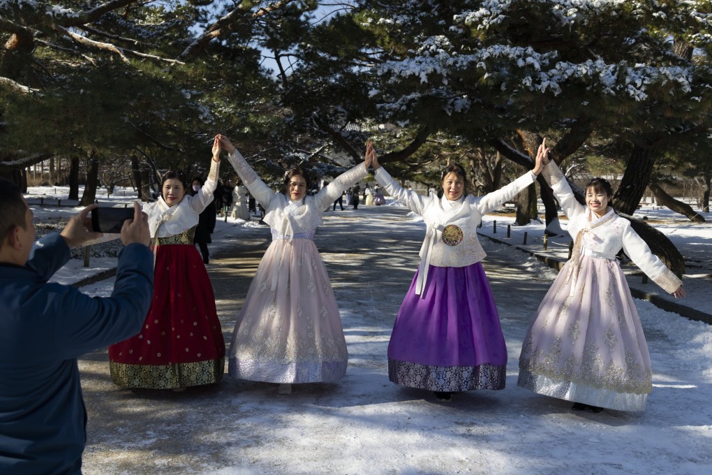 Tourists dressed in traditional Korean hanbok pose for photos at the Gyeongbokgung Palace in Seoul. Photo: EPA