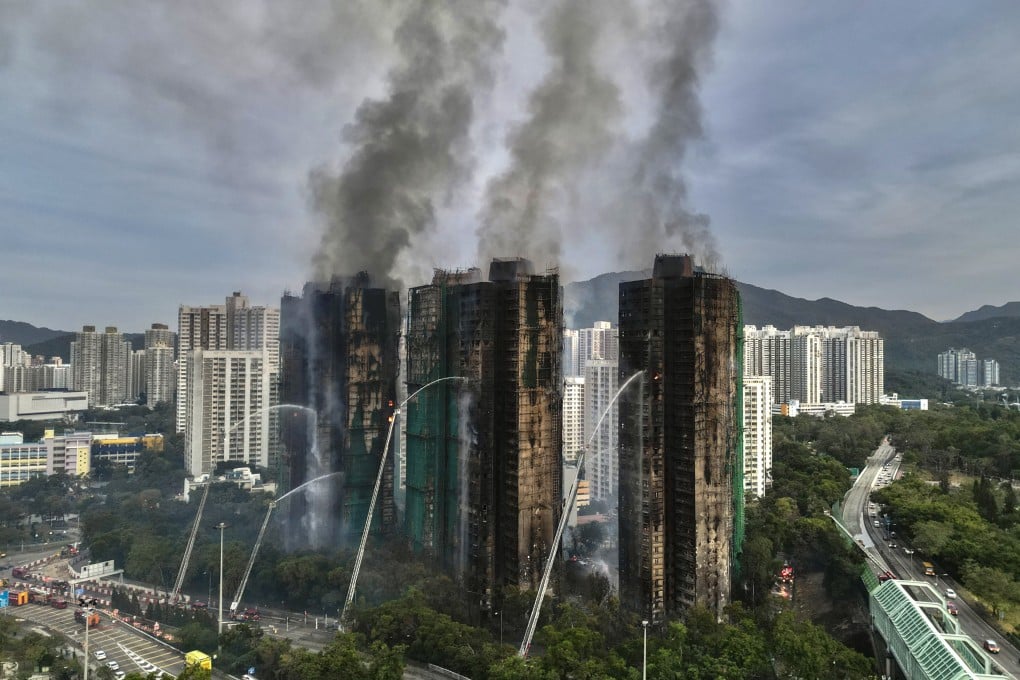 Firefighters shoot water on the towers of Wang Fuk Court in Tai Po on November 27. Photo: Karma Lo