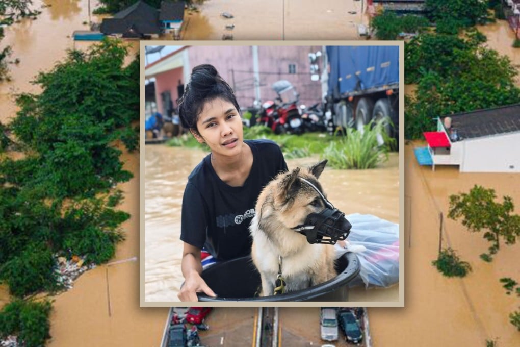 A Thai woman received online praise for staying on a rooftop with her dog and cat for three days during floods, refusing rescue unless her pets could join her. Photo: AP/FB@NewJazz Looknew