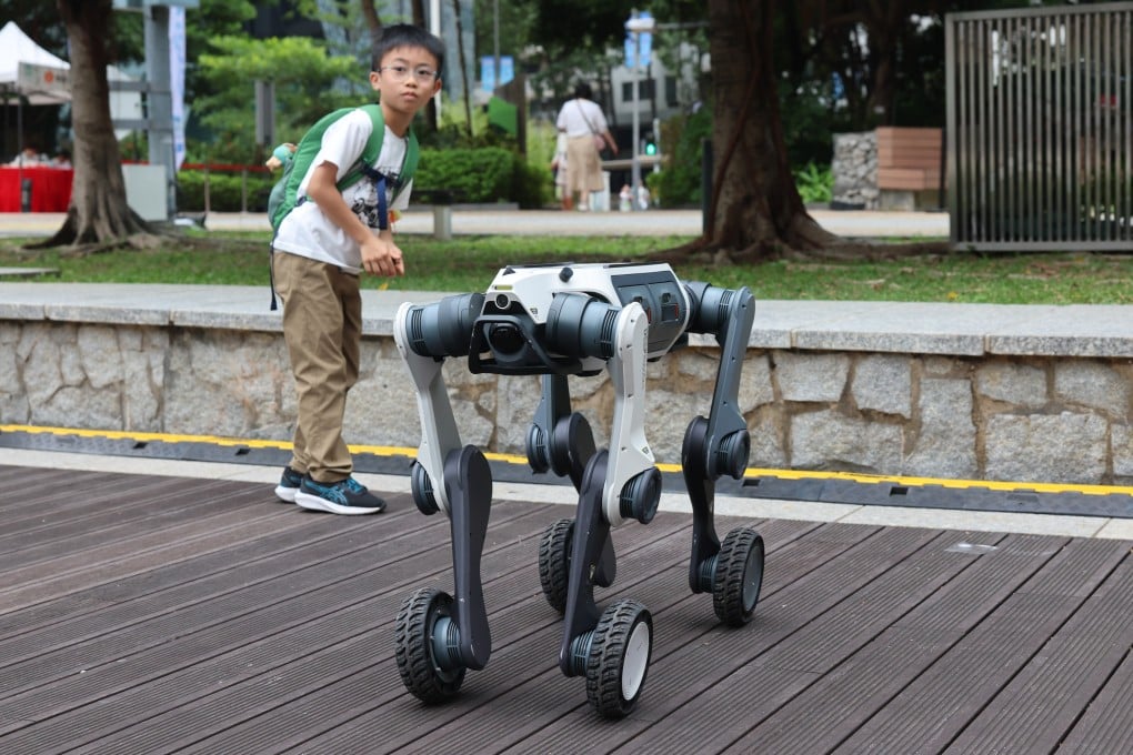 A child observes an industrial robot dog at the ZCP Future Mobility exhibition at Zero Carbon Park in Kowloon Bay on November 1. Photo: Dickson Lee