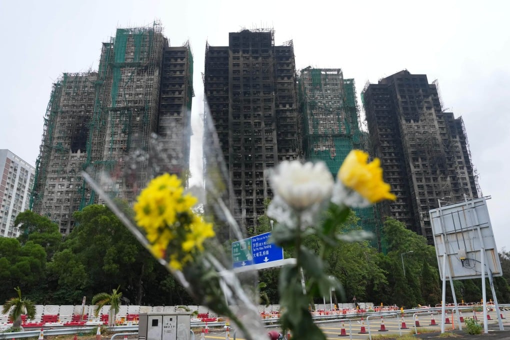Flowers are placed near Wang Fuk Court in Tai Po after last week’s deadly blaze. Photo: Karma Lo