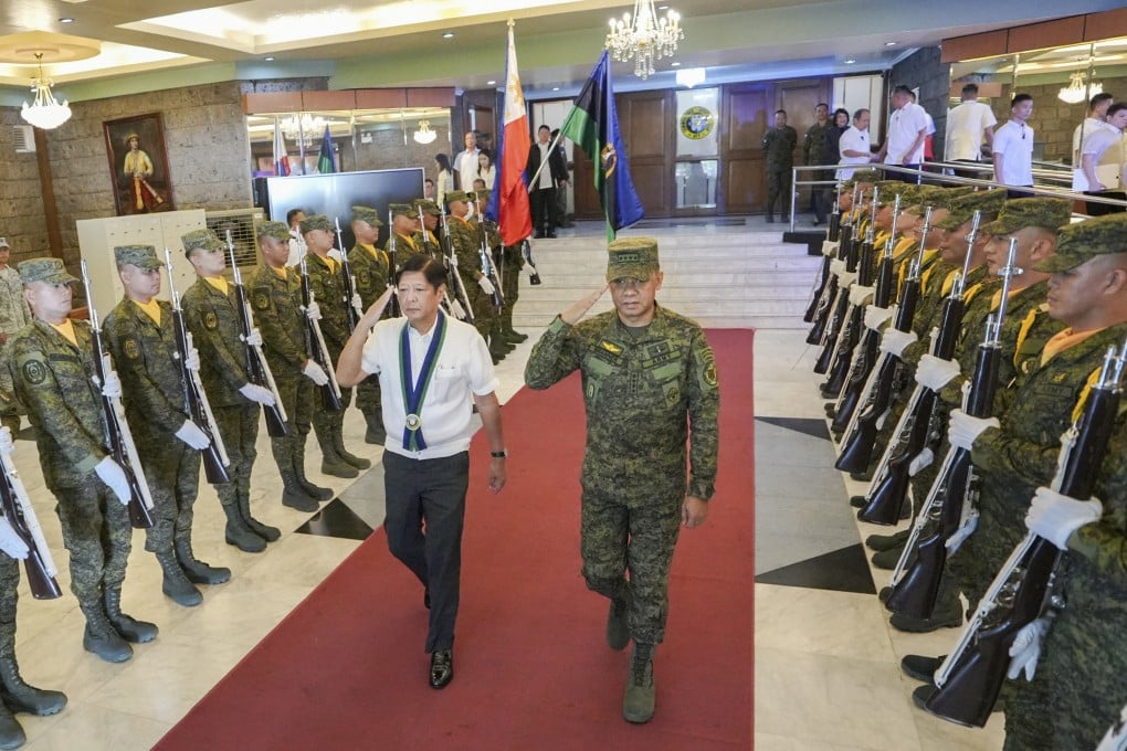 Philippine President Ferdinand Marcos Jnr walks with armed forces chief General Romeo Brawner Jnr at Camp Aguinaldo in Quezon City in July 2024. Brawner has since confirmed that the military is investigating alleged destabilisation efforts involving retired officers. Photo: AP