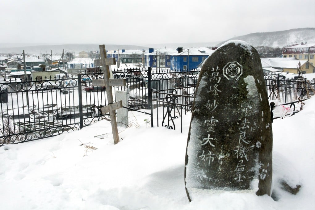 A Russian Orthodox cross next to a Japanese gravestone at a cemetery outside Kurilsk town on the island of Iturup, or Etorofu, one of four islands Japan calls the Northern Territories. Photo: AFP