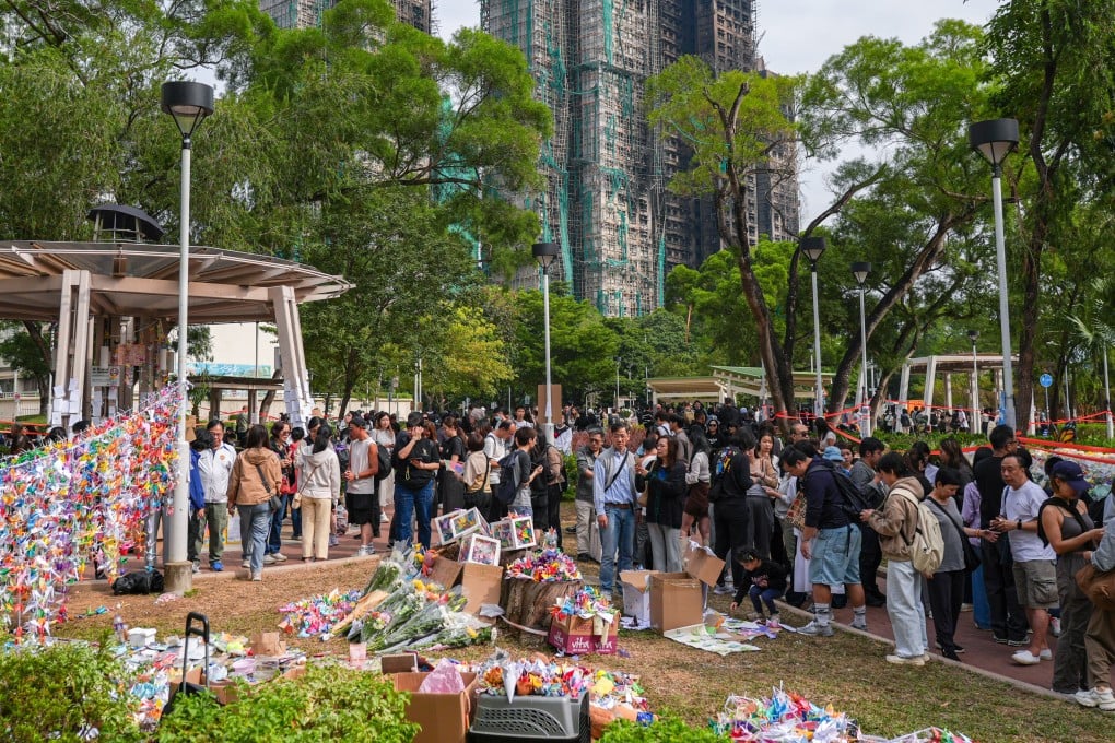Mourners gather near Wang Fuk Court in Tai Po on Sunday Photo: Eugene Lee