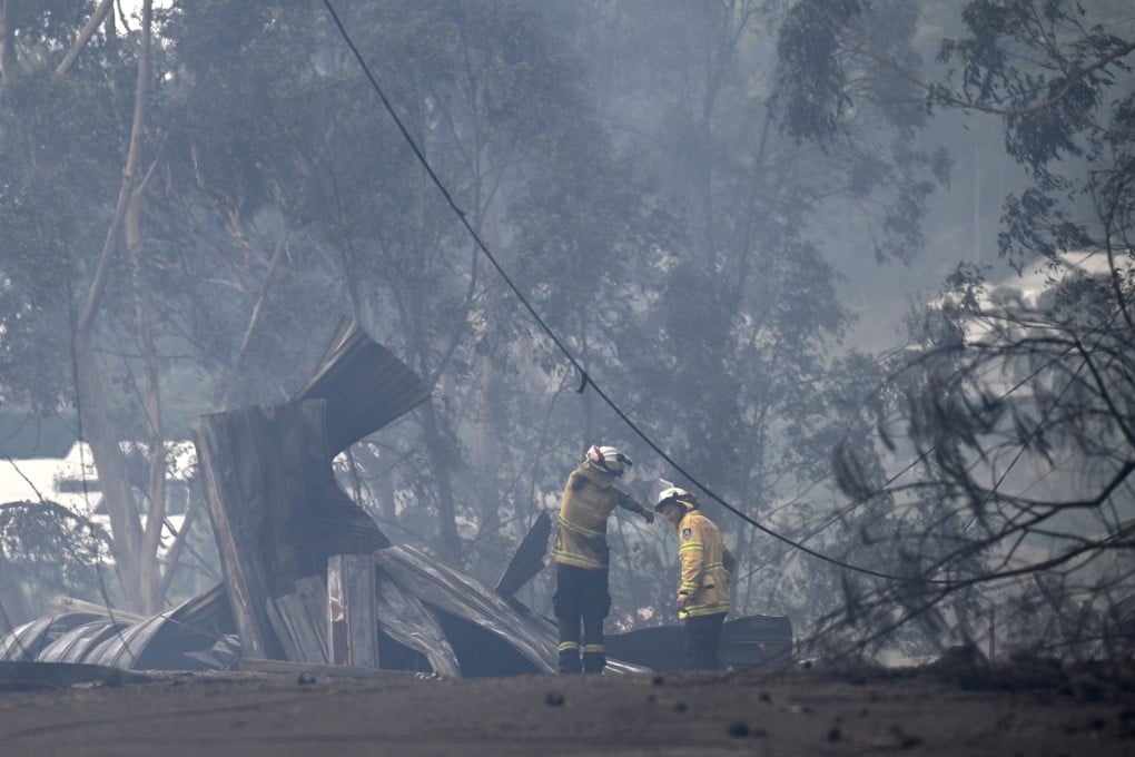 Firefighters work to put out a bushfire spreading through the Koolewong area on the Central Coast, New South Wales, on Saturday. Photo: EPA