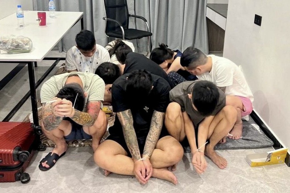 Suspects are detained during a police raid on a scam centre in Phnom Penh, Cambodia, on July 16. The operation was part of a nationwide crackdown on cybercrime networks, following Prime Minister Hun Manet’s order to shut down online scam operations often run like sweatshops. Photo: EPA