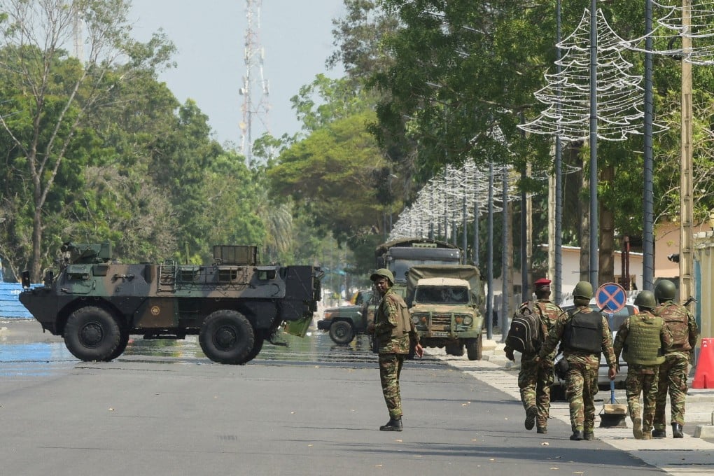 Soldiers patrol in front of the headquarters of Benin’s radio and television station after the country’s armed forces thwarted the attempted coup. Photo: Reuters