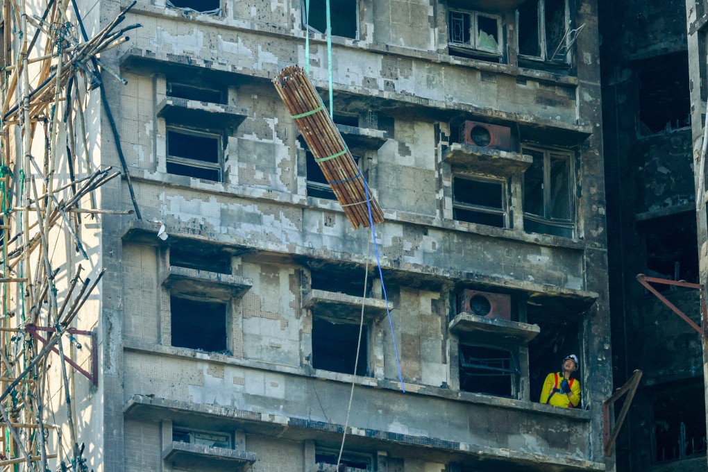 Bundles of steel bars being lifted to the upper floors of Wang Cheong House, the first building in Wang Fuk Court that caught fire on November 26. Photo: Dickson Lee