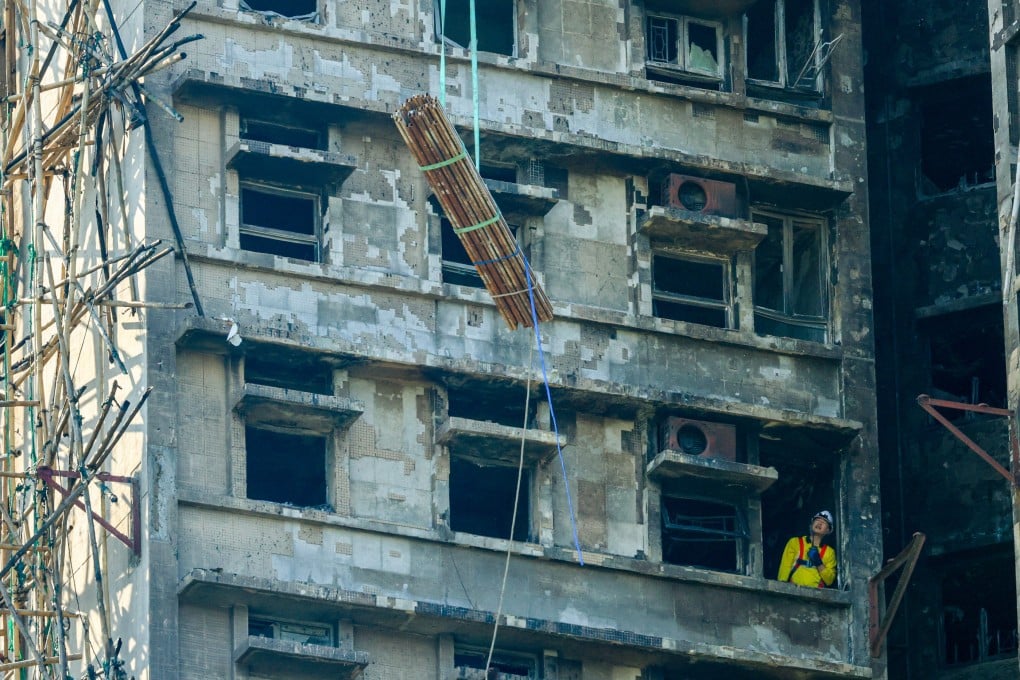 Bundles of steel bars being lifted to the upper floors of Wang Cheong House, the first building in Wang Fuk Court that caught fire on November 26. Photo: Dickson Lee