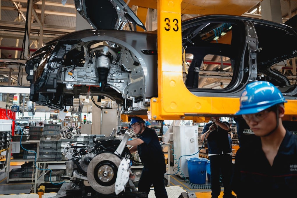 Labourers work on an assembly line at a factory in Chongqing, China, in May. Beijing has pressed German carmakers to help resolve disputes over the European Union’s anti-subsidy tariffs on Chinese electric vehicles. Photo: EPA-EFE