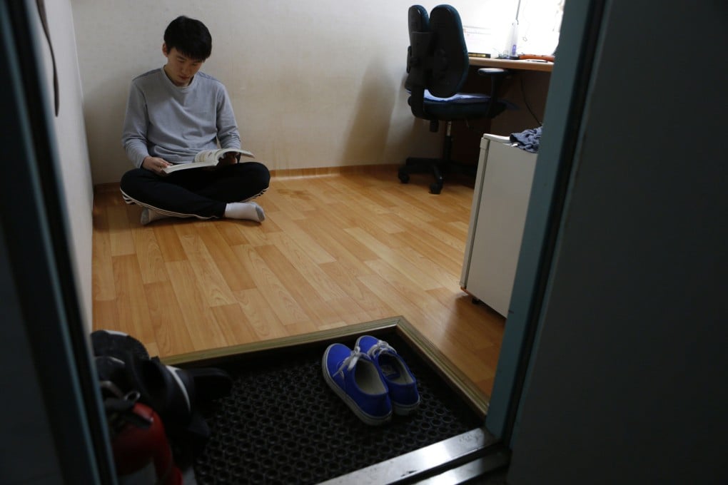 A man studies in his small room in a dormitory-style accommodation in Seoul, South Korea. Photo: Reuters