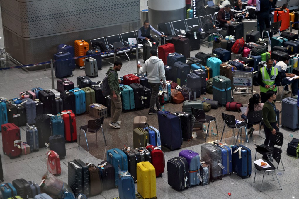 IndiGo employees tag stranded bags belonging to the airline’s passengers at Indira Gandhi International Airport in New Delhi on Monday following large-scale flight disruptions. Photo: Reuters