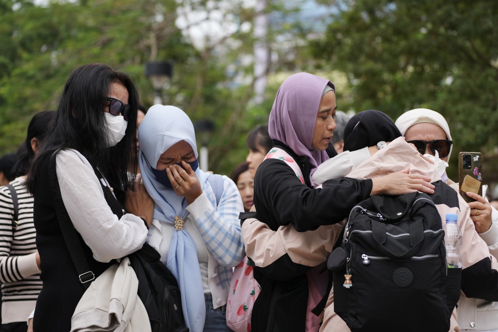 Domestic helpers mourn victims of the fire. Photo: Karma Lo