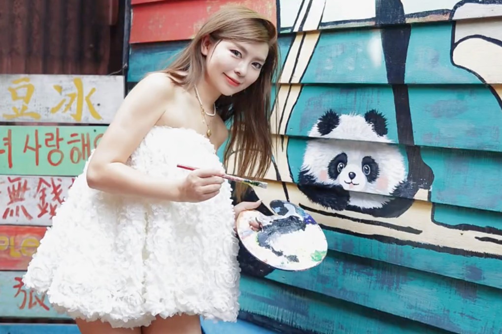 Shen Shishi with her finished painting of a panda. Photo: Handout