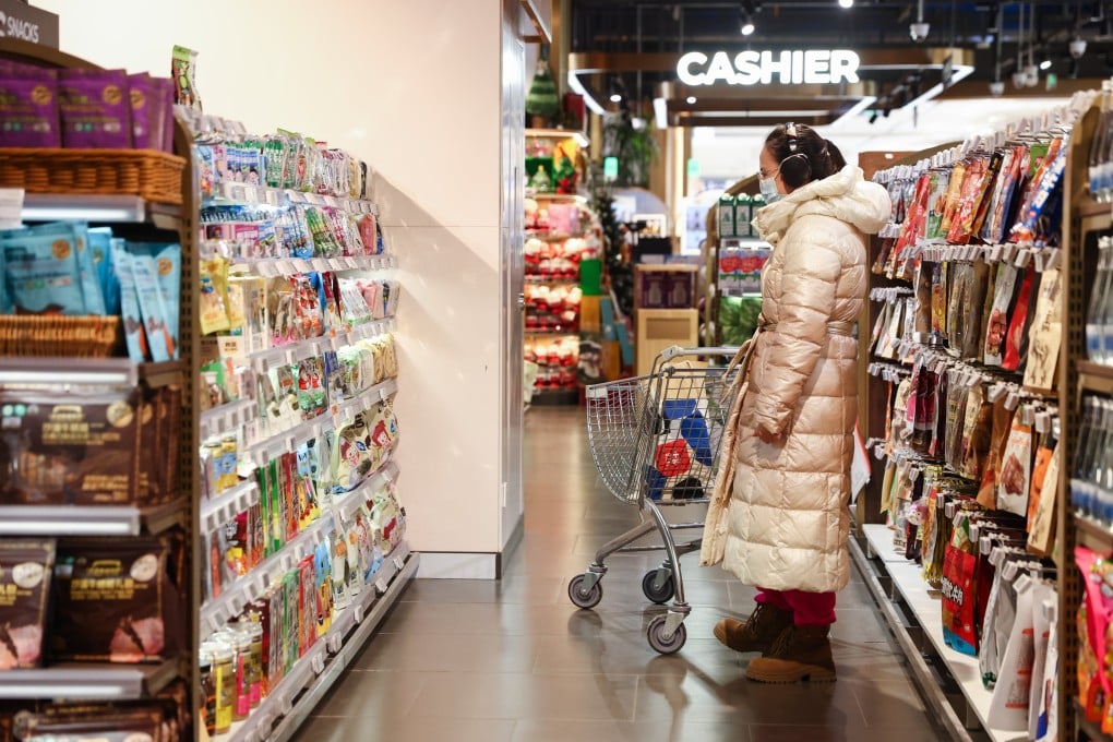 A woman shops in a supermarket in Beijing on December 8, 2025. Photo: EPA