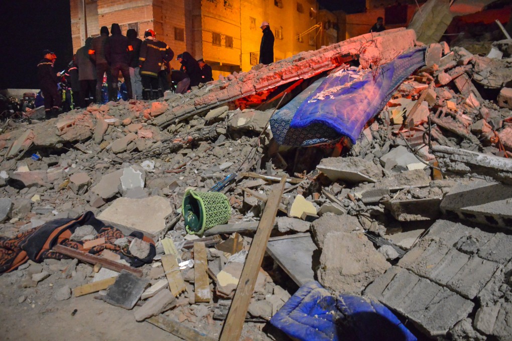 Rescue workers and residents search for survivors amid the wreckage of two collapsed buildings in Fez, Morocco on Tuesday. Photo: AP