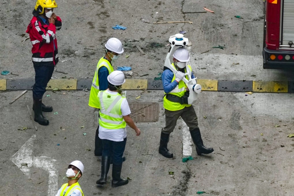 Officials carry out a survey at the scene of the deadly Tai Po blaze. Photo: Karma Lo