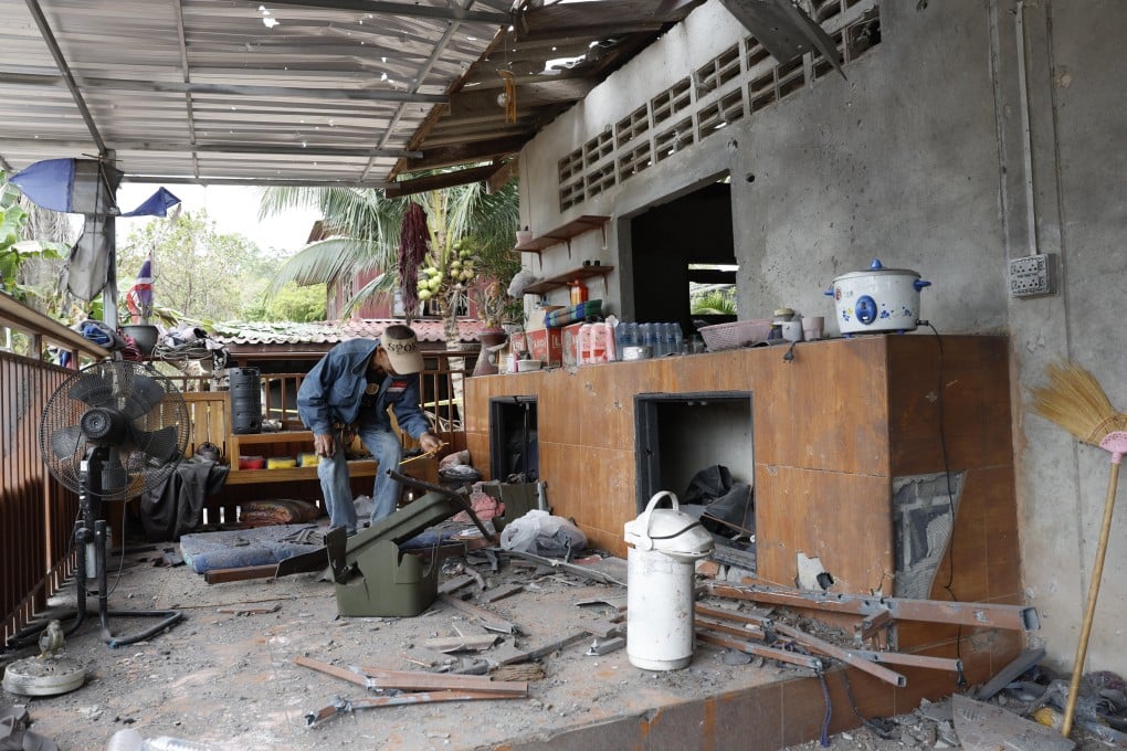 A Thai villager inspects his house damaged during clashes between Thai and Cambodian troops, at a village in Surin province, Thailand, on Tuesday. Photo: EPA