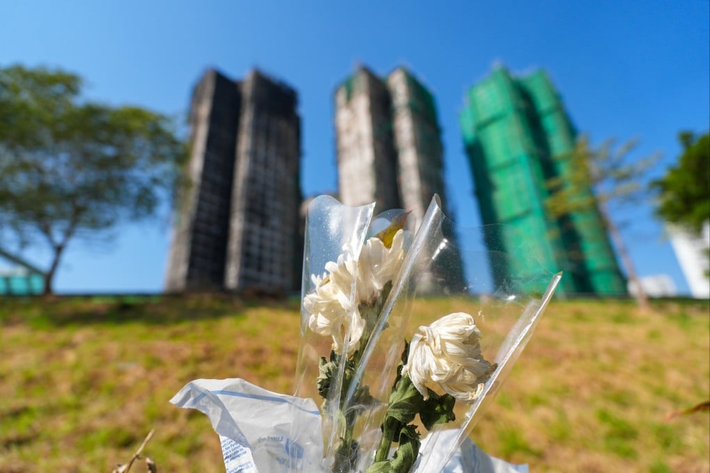 Flowers are placed in mourning near Wang Fuk Court in Hong Kong’s Tai Po district on December 9, two weeks after the deadly fire that killed at least 159 people. Photo: Eugene Lee