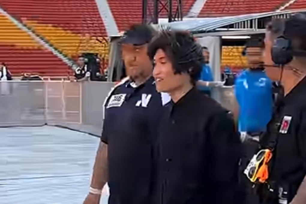 Johnson Wen is seen being escorted out of a concert venue in Brisbane, Australia. Photo: Handout