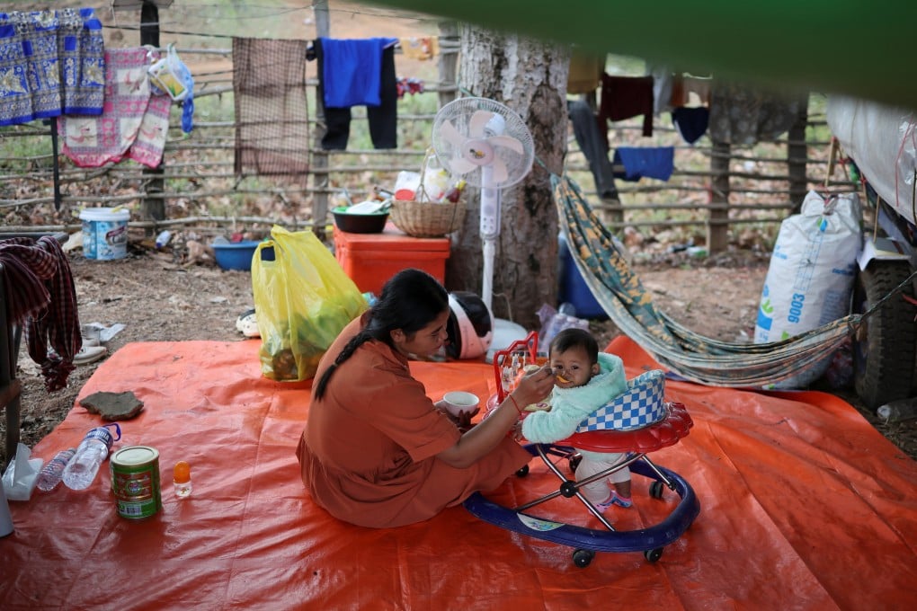 A woman feeds a child at a refugee camp after evacuation following the border clashes between Cambodia and Thailand in Srei Snam, Cambodia’s Siem Reap province, on Wednesday. Photo: Reuters
