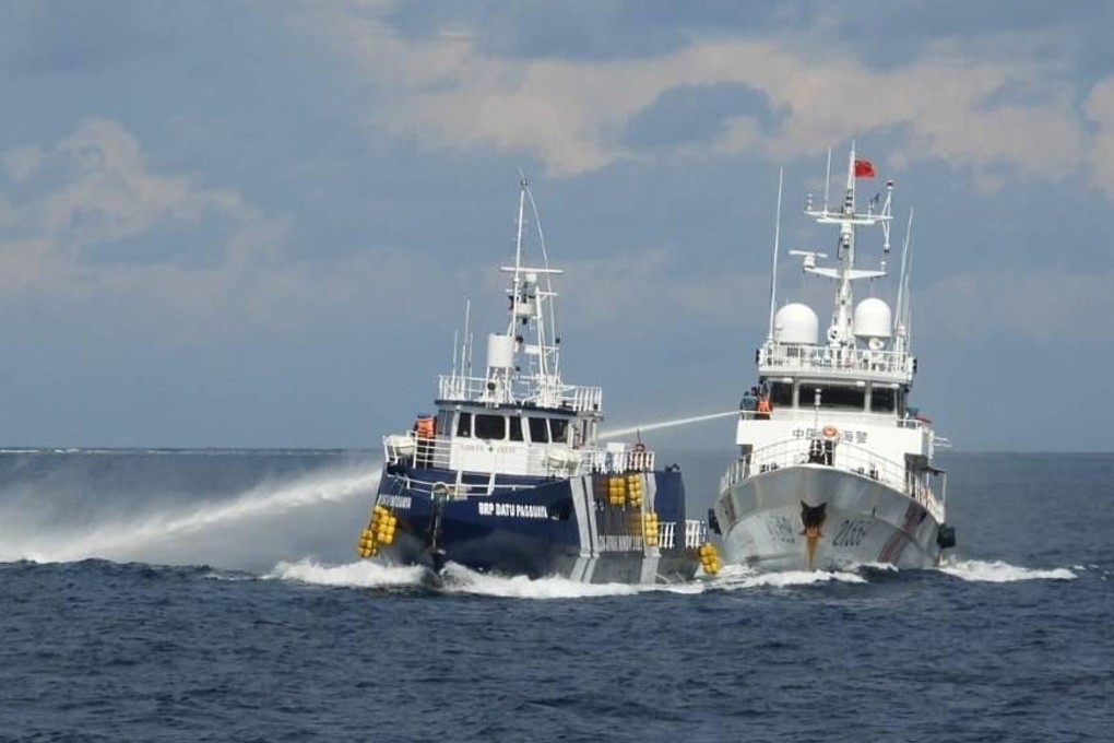 A Chinese coastguard vessel (right) fires its water cannon at the Philippine’s BRP Datu Pagbuaya in the South China Sea on October 12. Photo: Philippine Coast Guard via AP
