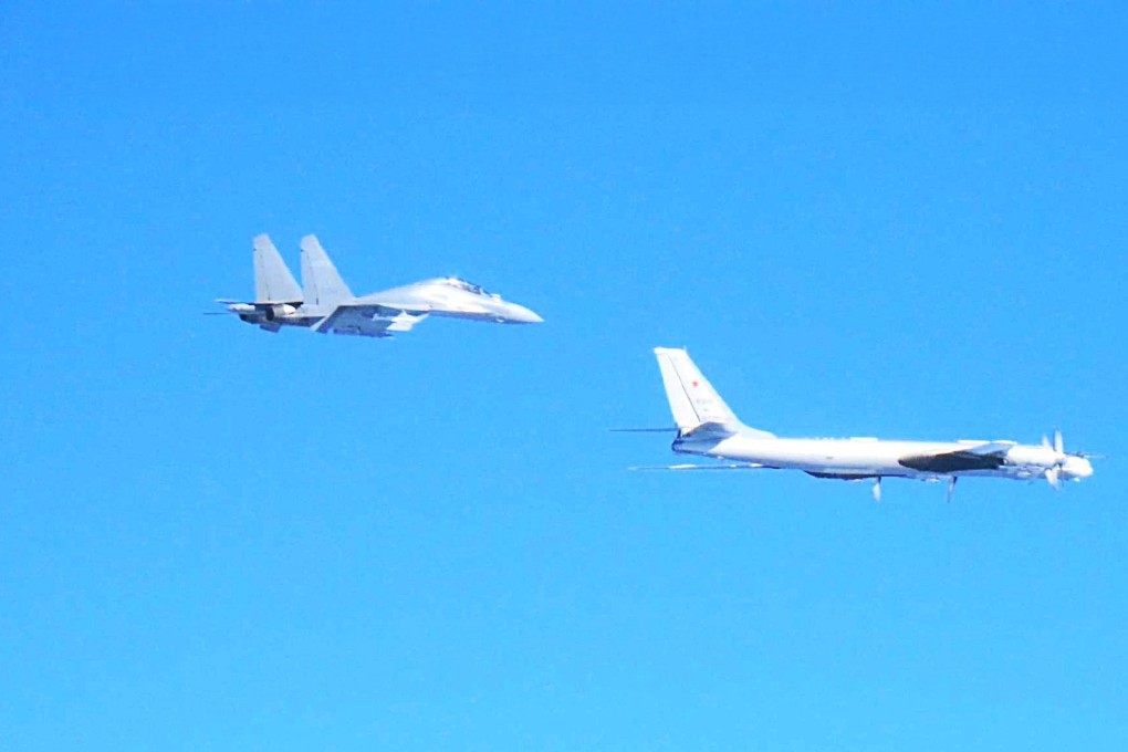 A Chinese J-16 fighter and a Russian Tu-95 bomber. Photo: Handout