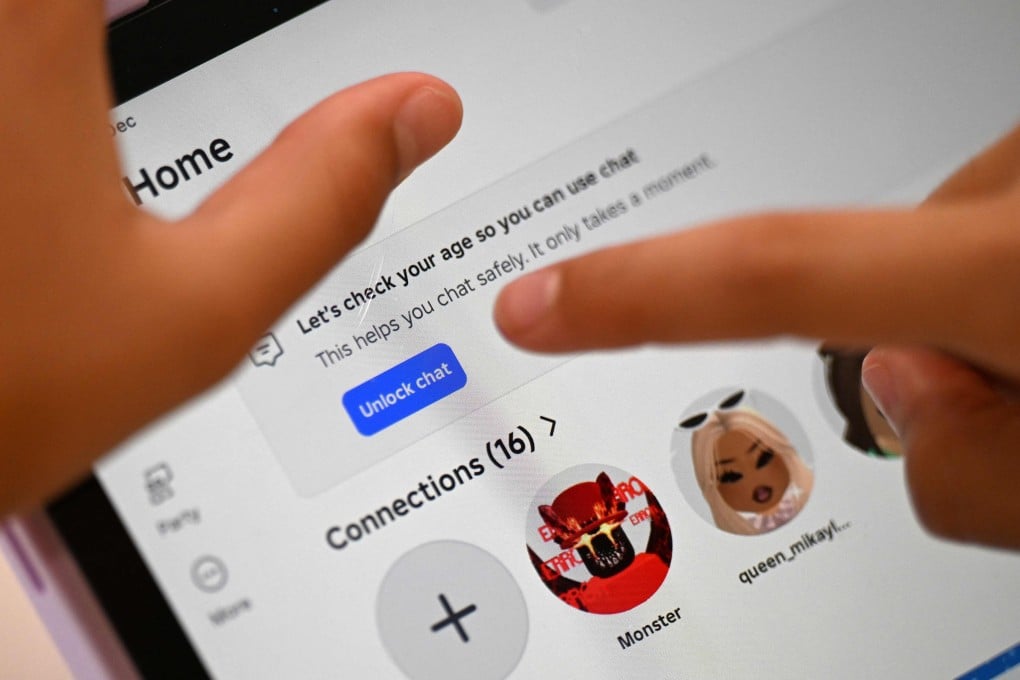 A child tries to unlock a social media site after receiving an age verification message at her home in Sydney on December 10. Photo: AFP