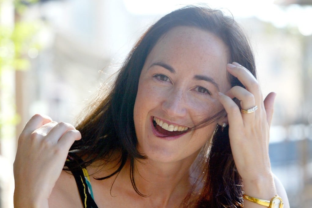 Author Sophie Kinsella poses on Wimbledon Village high street, London in 2004. Photo: AP
