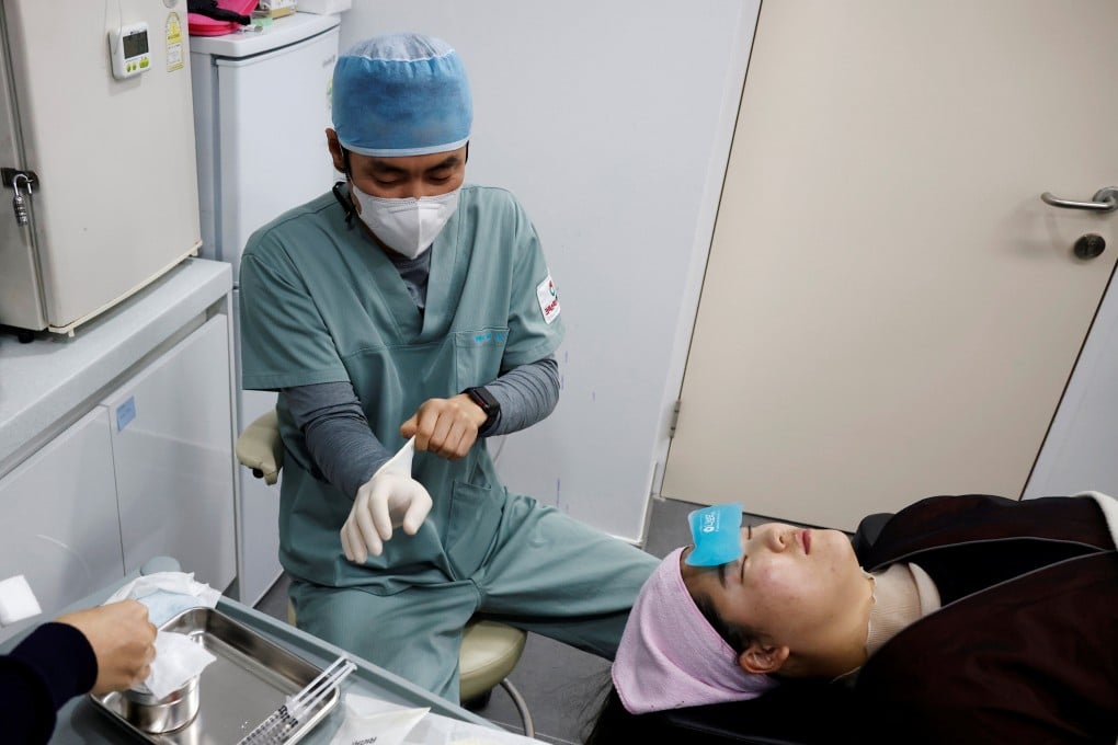 Shin Sang-ho, director of Krismas Plastic Surgery in Seoul, prepares to administer a Botox injection in December 2020. Photo: Reuters