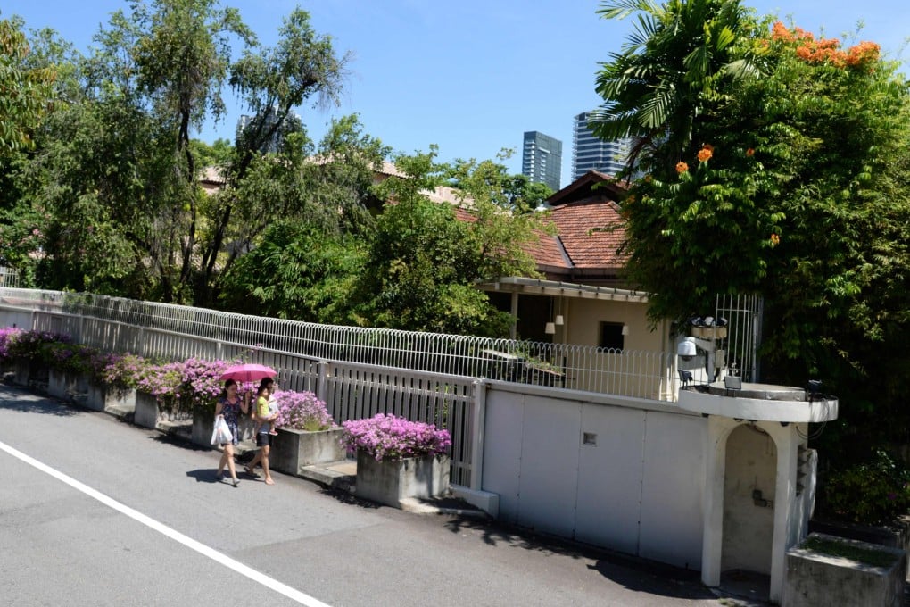 Residents walking past the house of Singapore’s late prime minister Lee Kuan Yew on 38 Oxley Road in Singapore. Photo: AFP