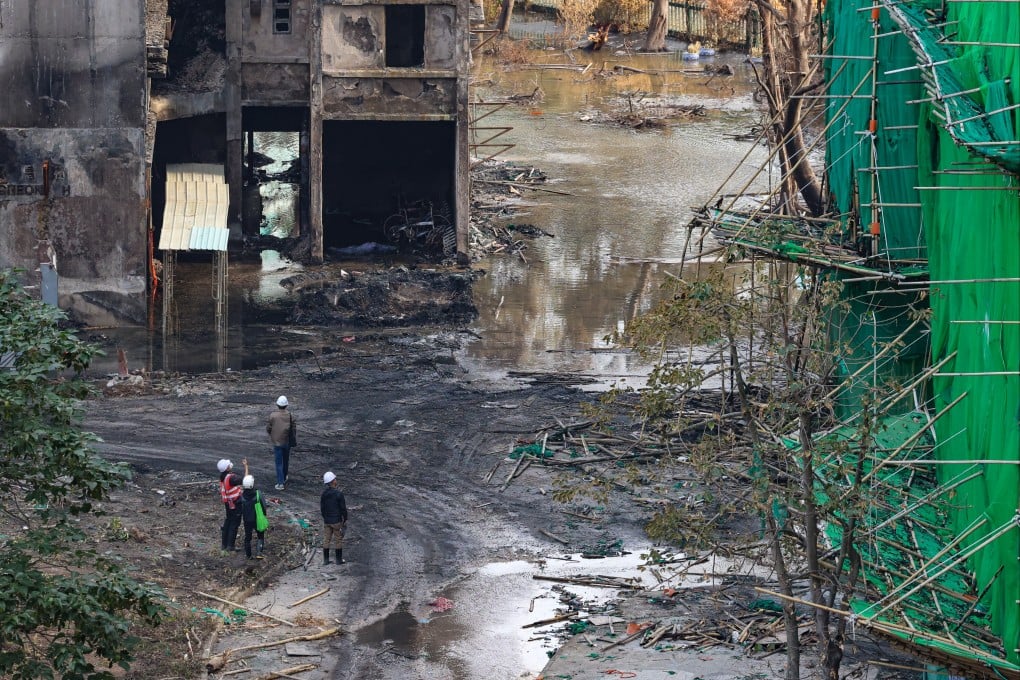 Workers assess the damage in the aftermath of the deadly fire at Wang Fuk Court in Tai Po on December 11. Photo: Jelly Tse
