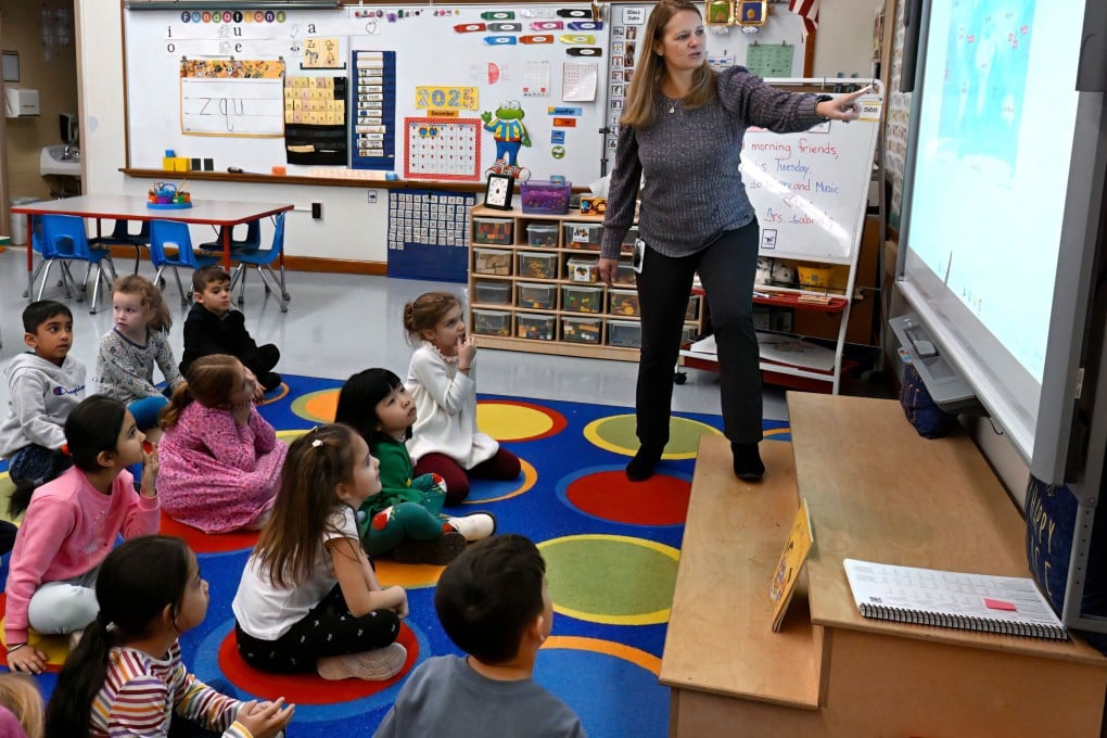 Webster Hill Elementary School teacher Christin Labriola points out countries on a map during a lesson incorporating Asian-American and Pacific Islander subjects on December 2. Photo: AP