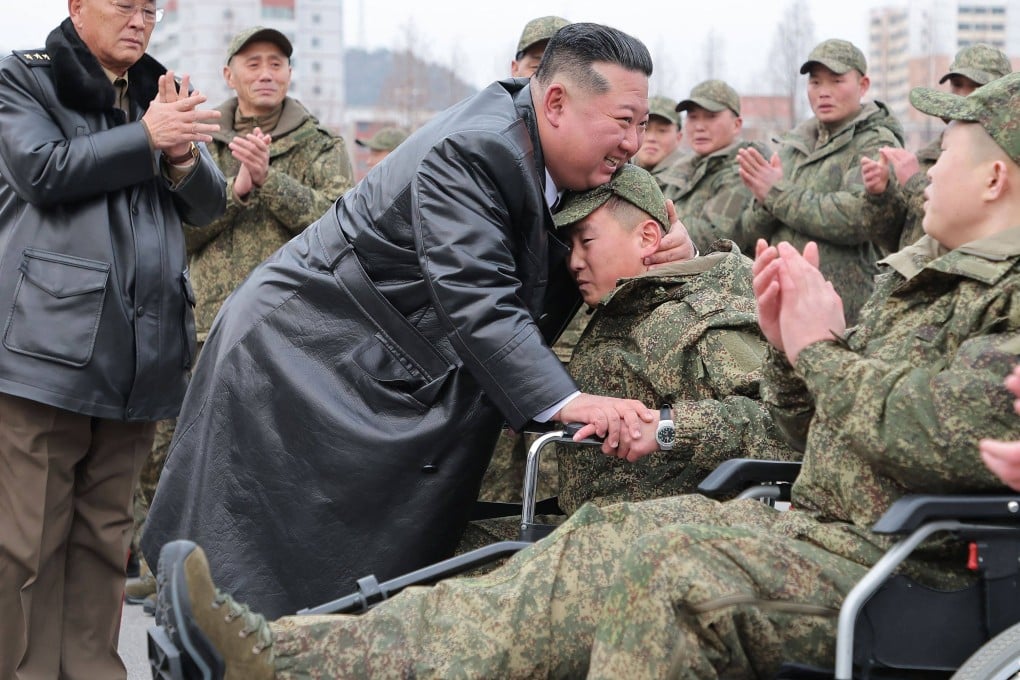 North Korean leader Kim Jong-un hugs a soldier from the Korean People’s Army’s 528th Regiment of Engineers in a photo released on Saturday. Photo: KCNA/AFP