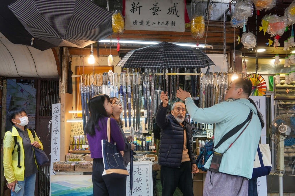 Yau Yiu-wai (black jacket), 73, owner of Sun Nga Shing Umbrella Store in Sham Shui Po, has enjoyed a recent bump in sales but will nonetheless close his 183-year-old business by the end of this month. Photo: Sam Tsang