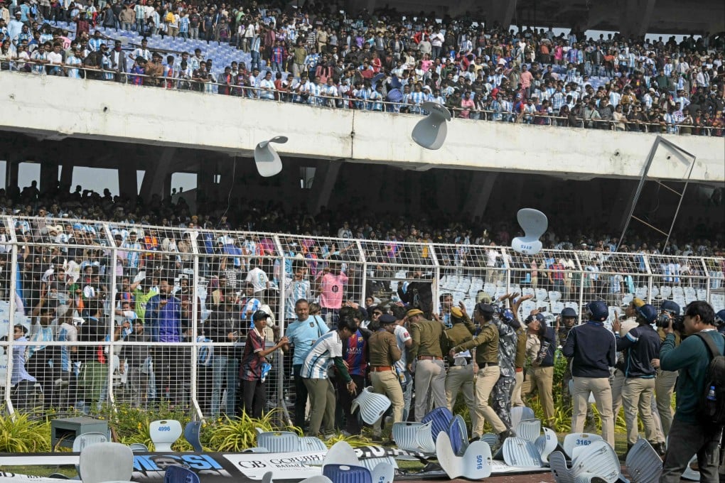 Fans throw chairs after Lionel Messi departs from the Salt Lake Stadium in Kolkata on Saturday. Photo: AFP