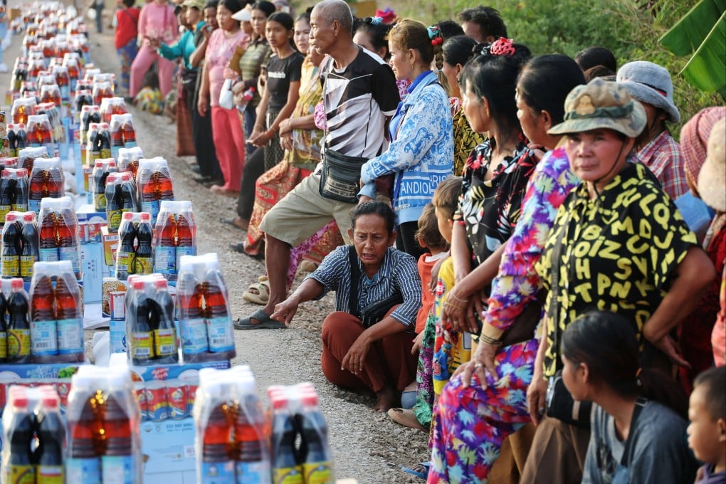 People wait to receive supplies on Saturday at a refugee camp in Banteay Meanchey province in Cambodia amid border clashes between Thailand and Cambodia. Photo: Reuters