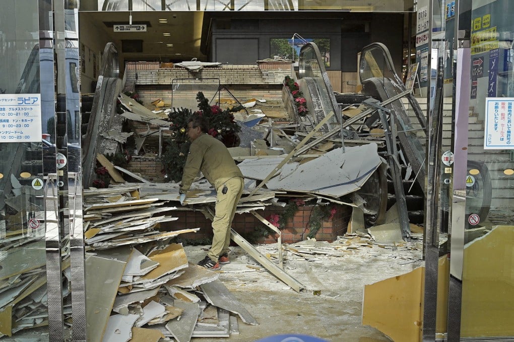 A worker cleans up inside a shopping centre in Hachinohe in Aomori prefecture on Tuesday. Photo: Kyodo/Reuters