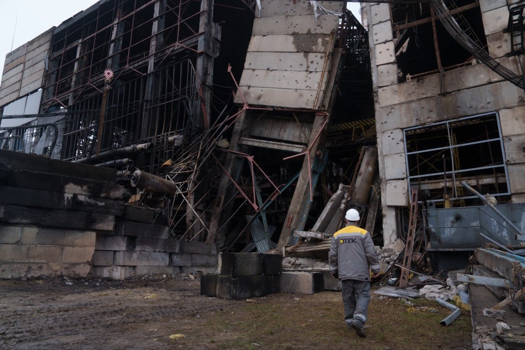 A Ukrainian power plant worker walks in front of a damaged production hall after a Russian missile attack this month. Photo: AP