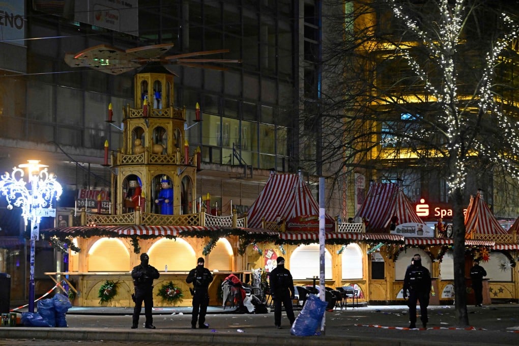 Security forces stand guard at the entrance of a Christmas market where a car crashed into a crowd and killed six people last December in Magdeburg, Germany. Photo: AFP