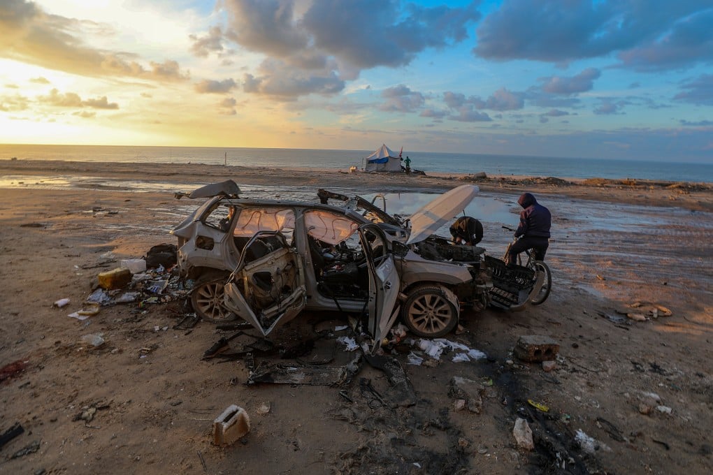 A car destroyed in an Israeli strike is seen on Saturday near the Nablusi junction in the Gaza City area. Photo: EPA
