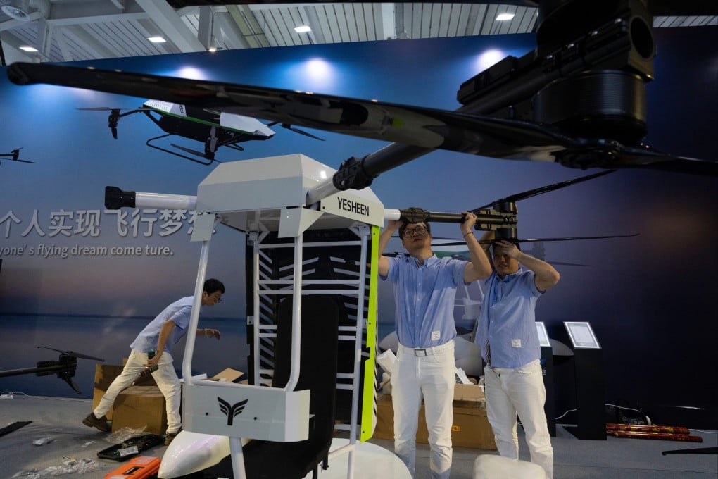 Workers assemble a flying vehicle at an expo on the low-altitude economy in Shenzhen, on September 23. Hong Kong needs to work closely with growth areas, particularly the rest of the Greater Bay Area, to help build a strong domestic market. Photo: AP